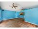 Spacious living room with hardwood floors, multiple ceiling fans, and natural light streaming in through the windows at 124 Maluli Dr, Oxford, NC 27565
