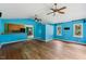Large living room with hardwood floors, ceiling fans, and a view of the kitchen at 124 Maluli Dr, Oxford, NC 27565