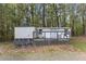 Exterior of a back yard outbuilding with lattice trim and an adjacent shed at 124 Maluli Dr, Oxford, NC 27565