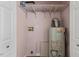 Functional utility room with shelving, water heater, and hookups providing convenience at 124 Maluli Dr, Oxford, NC 27565