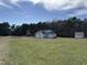 Exterior view of the property with a house and a shed on a grass-filled lot at 1278 Valley Ct, Zebulon, NC 27597