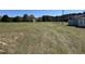 Expansive grassy property featuring a structure in the distance, offering a sense of space and possibilities at 1278 Valley Ct, Zebulon, NC 27597