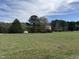 Exterior shot of a property featuring multiple small buildings on a large grassy lot, showcasing a secluded setting at 1278 Valley Ct, Zebulon, NC 27597