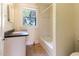 Bathroom with tub, shower, vanity and window with view to outdoors at 1308 Wake Forest Rd, Raleigh, NC 27604
