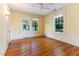 Bedroom featuring hardwood floors, three windows and overhead lighting at 1308 Wake Forest Rd, Raleigh, NC 27604