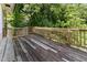 Outdoor deck with railings and lush landscaping surrounding the home at 1308 Wake Forest Rd, Raleigh, NC 27604