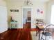 Cozy dining room features hardwood floors, 'wine' decor, vintage chandelier, and natural light at 1308 Wake Forest Rd, Raleigh, NC 27604