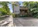Rear exterior of home featuring a multi-level deck, driveway, and lush greenery at 1308 Wake Forest Rd, Raleigh, NC 27604