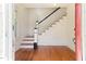 Bright foyer with hardwood floors and an elegant staircase at 1308 Wake Forest Rd, Raleigh, NC 27604