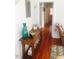 Entry hall with hardwood floors, books, console table and view into living space at 1308 Wake Forest Rd, Raleigh, NC 27604