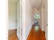 Hallway with hardwood floors and white trim leading to other rooms at 1308 Wake Forest Rd, Raleigh, NC 27604