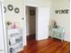 Bright living room with hardwood floors, decorative mirrors and wine themed decor at 1308 Wake Forest Rd, Raleigh, NC 27604