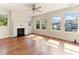 Sun-drenched living room features a decorative fireplace and hardwood floors with lots of windows at 1308 Wake Forest Rd, Raleigh, NC 27604