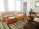 Comfortable living room featuring a sectional sofa, patterned rug, and lots of natural light at 1308 Wake Forest Rd, Raleigh, NC 27604
