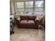Sunny room with neutral tile, leather loveseat and bicycles at 1308 Wake Forest Rd, Raleigh, NC 27604