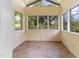 Sunroom with lots of windows, vaulted ceilings, and ceramic tile floors at 1308 Wake Forest Rd, Raleigh, NC 27604