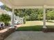 Backyard view from a covered patio, showing a spacious lawn, deck, and surrounding trees, perfect for outdoor enjoyment at 132 Crystal Pl, Benson, NC 27504