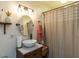 Bathroom featuring a stylish vessel sink, modern lighting, and a decorative shower curtain, exuding contemporary charm at 132 Crystal Pl, Benson, NC 27504