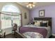 Charming bedroom with a large window, decorative pillows, and a cozy quilt, creating a serene and inviting atmosphere at 132 Crystal Pl, Benson, NC 27504