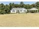 Front view of a charming one-story house with a well-manicured lawn and carport at 132 Crystal Pl, Benson, NC 27504