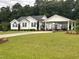 Traditional home featuring white siding, black shutters, a covered carport, and a well-manicured lawn at 132 Crystal Pl, Benson, NC 27504