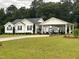 Traditional home featuring white siding, black shutters, a covered carport, and a well-manicured lawn at 132 Crystal Pl, Benson, NC 27504