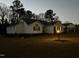 Charming single-story home with a well-maintained lawn and inviting curb appeal at twilight at 132 Crystal Pl, Benson, NC 27504