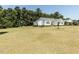 Traditional home featuring white siding, black shutters, a covered carport, and a well-manicured lawn at 132 Crystal Pl, Benson, NC 27504