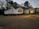 Charming single-story home with a well-maintained lawn and inviting curb appeal at twilight at 132 Crystal Pl, Benson, NC 27504