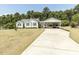 Exterior view of a charming home with a circular driveway and carport at 132 Crystal Pl, Benson, NC 27504