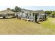 View of the home's exterior, featuring a white fence, lawn, covered deck, and carport at 132 Crystal Pl, Benson, NC 27504