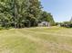 Large green lawn with a view of the rear exterior and white cottage at 132 Crystal Pl, Benson, NC 27504