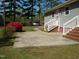 Back patio with stairs, a seating area, and view of greenery, perfect for outdoor relaxation and entertainment at 136 Scramble Rd, Erwin, NC 28339