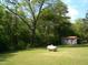 Spacious backyard featuring a shed and propane tank on a large grassy lot with trees at 136 Scramble Rd, Erwin, NC 28339