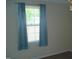 Cozy bedroom with plush carpeting and a window with neutral curtains at 136 Scramble Rd, Erwin, NC 28339