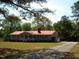 Charming home with a red roof, red shutters, and a well-manicured lawn at 136 Scramble Rd, Erwin, NC 28339