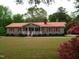 Charming ranch-style home featuring a red roof, matching shutters, and a well-manicured front lawn at 136 Scramble Rd, Erwin, NC 28339