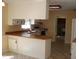 Spacious kitchen with white cabinets, breakfast bar, and linoleum floors at 136 Scramble Rd, Erwin, NC 28339