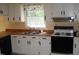 Well-lit kitchen featuring white cabinets, wood countertops, and a double sink at 136 Scramble Rd, Erwin, NC 28339