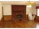 A living room featuring hardwood floors and a brick fireplace at 136 Scramble Rd, Erwin, NC 28339