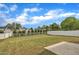 Large backyard showcasing an expansive lawn area with white fencing for privacy and security at 138 Tanglewood Pl, Angier, NC 27501