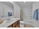 Bathroom featuring a single vanity and a shower over tub, complete with wood look floors at 138 Tanglewood Pl, Angier, NC 27501