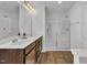 Bathroom featuring a dual vanity and a glass enclosed shower with wood look floors at 138 Tanglewood Pl, Angier, NC 27501