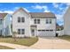 Charming two-story home with white siding, a two-car garage, and inviting curb appeal at 138 Tanglewood Pl, Angier, NC 27501