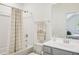 Well-lit bathroom featuring a shower-tub combo, vanity, and neutral color scheme at 143 Sallyport Ct, Raleigh, NC 27603