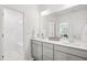 Bright bathroom featuring double sinks, neutral cabinets, and a tub and shower combo at 143 Sallyport Ct, Raleigh, NC 27603