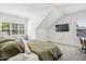 Bright bedroom features plush carpet, a large window, and a wall-mounted television at 143 Sallyport Ct, Raleigh, NC 27603