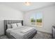 Bedroom with a comfortable upholstered bed and soft neutral colors at 143 Sallyport Ct, Raleigh, NC 27603