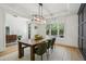 Stylish dining room with wood table, wainscoting, large window, and decorative lighting at 143 Sallyport Ct, Raleigh, NC 27603