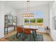 Well-lit dining room with a modern chandelier and view of the community at 143 Sallyport Ct, Raleigh, NC 27603